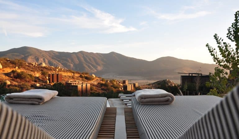 sunloungers fronting buildings near mountain